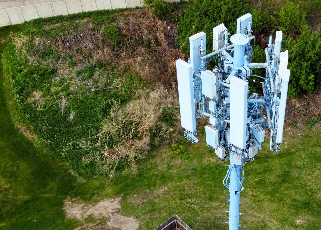 A cellular tower and its equipment compound seen from above by drone