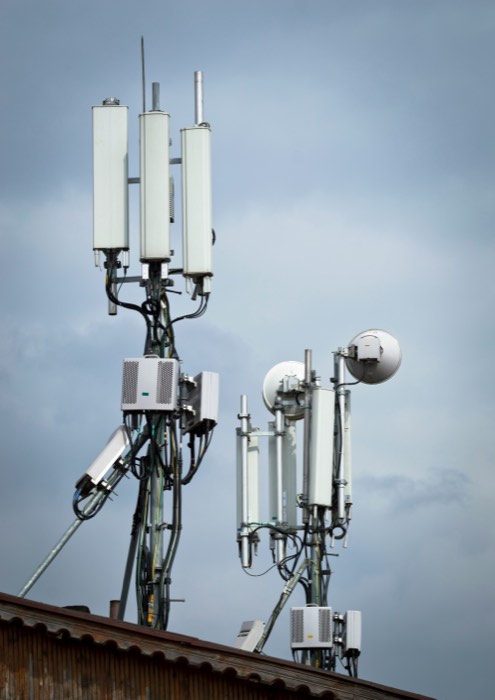Cellular antennas and microwave dishes mounted on a communications structure